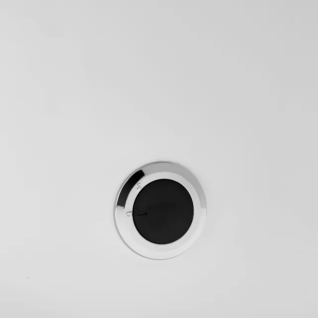 Close-up of a round button low on the side of the K1